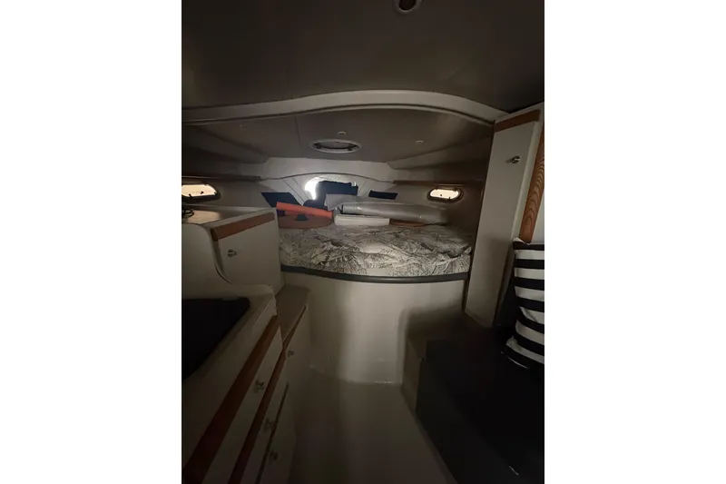 Slide: The Image of Interior cabin of 1999 Four Winns 328 Vista boat with bed and storage. - 24