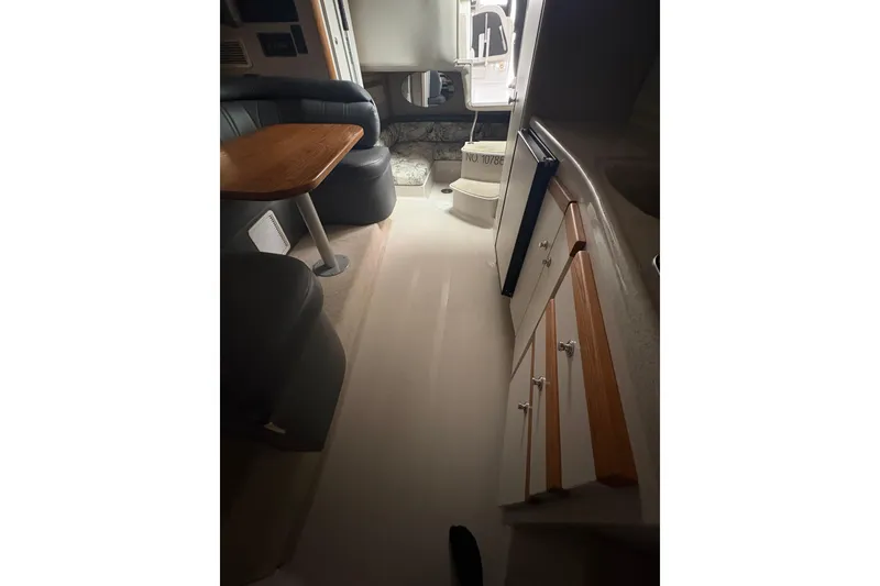 Slide: The Image of Interior of 1999 Four Winns 328 Vista boat, featuring seating and cabinetry. - 26