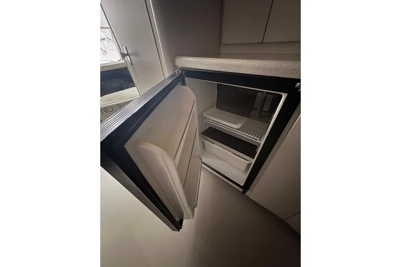 Slide: The Image of Open refrigerator inside 1999 Four Winns 328 Vista boat cabin. - 31