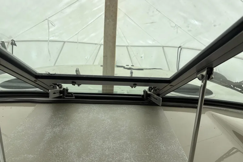Slide: The Image of 1999 Four Winns 328 Vista boat hatch view with open window and protective cover. - 44