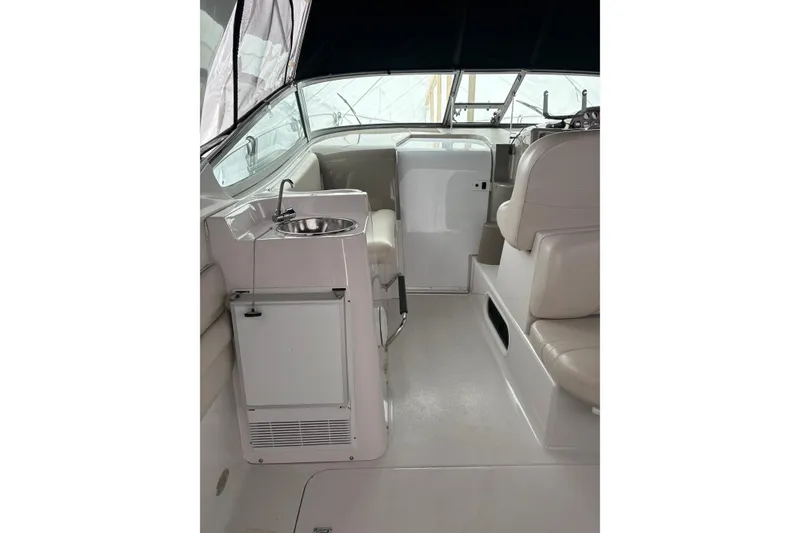 Slide: The Image of 1999 Four Winns 328 Vista boat interior with sink and seating area. - 6