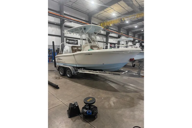 The Image of 2023 Pioneer 202 Islander boat on trailer in indoor showroom. - 1