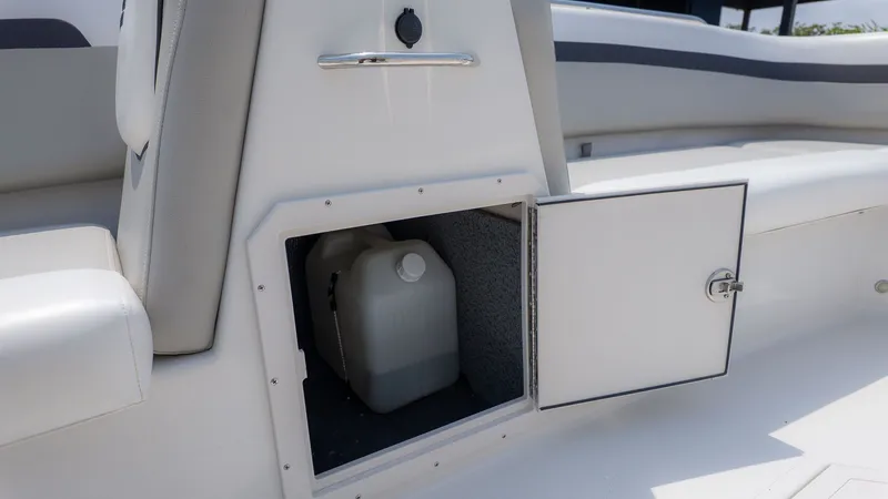 Slide: The Image of Starcraft 191SVX 2023 boat with open storage compartment and canister. - 11