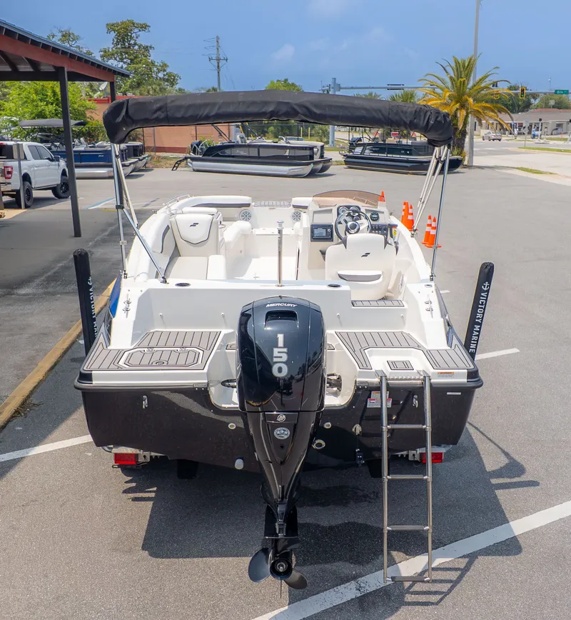 Slide: The Image of 2023 Starcraft 191SVX boat with outboard motor and bimini top. - 4