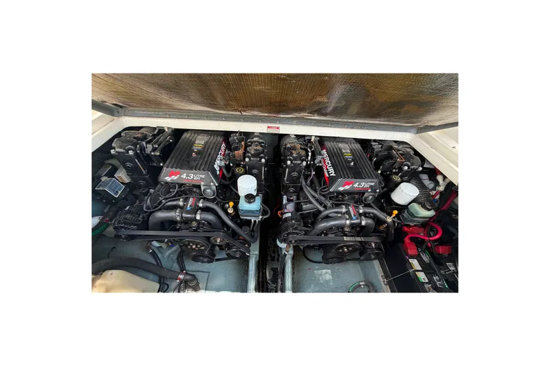 Slide: The Image of Twin Mercury engines in a 2000 Sea Ray 270 Sundancer boat, showcasing engine compartment. - 17