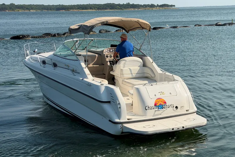 Slide: The Image of 2000 Sea Ray 270 Sundancer boat cruising on a calm lake. - 3