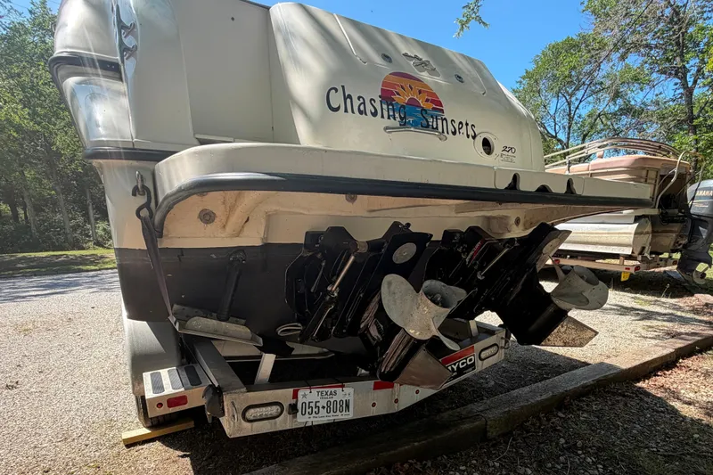 Slide: The Image of Rear view of a 2000 Sea Ray 270 Sundancer boat on a trailer, showcasing dual propellers. - 15