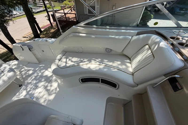 Slide: The Image of Interior seating of 2000 Sea Ray 270 Sundancer boat, featuring white leather upholstery. - 27