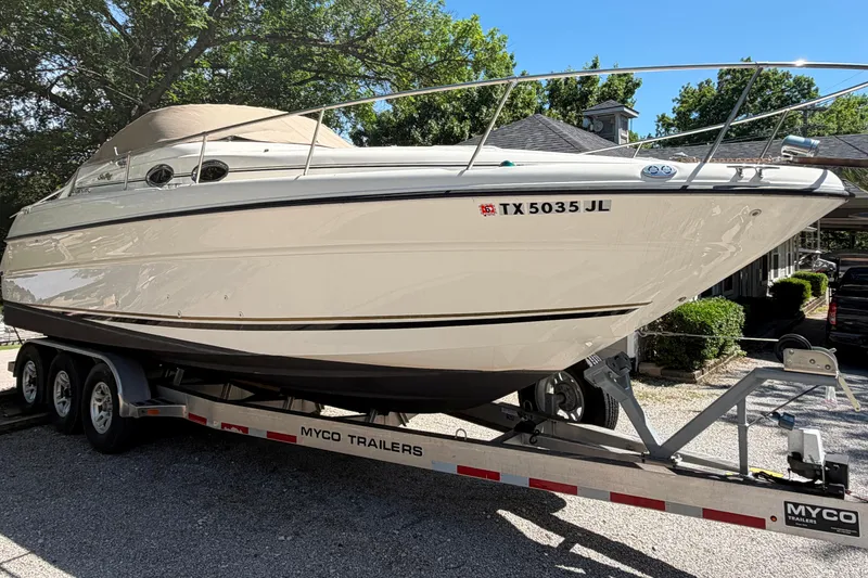 Slide: The Image of 2000 Sea Ray 270 Sundancer boat on trailer, parked outdoors. - 12