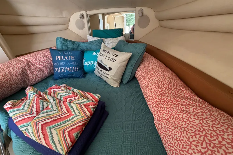 Slide: The Image of Cozy cabin interior of 2000 Sea Ray 270 Sundancer with decorative pillows and bedding. - 39