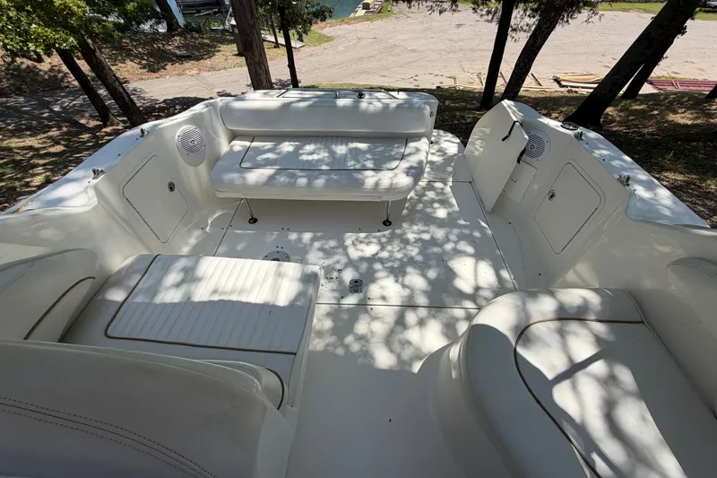 Slide: The Image of 2000 Sea Ray 270 Sundancer boat interior with white seating and storage compartments. - 35