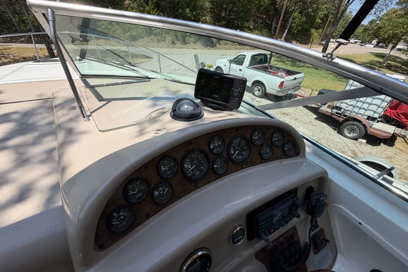 Slide: The Image of Dashboard of a 2000 Sea Ray 270 Sundancer boat with gauges and navigation equipment. - 24