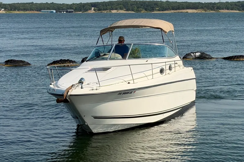 Slide: The Image of 2000 Sea Ray 270 Sundancer boat cruising on a calm lake. - 6