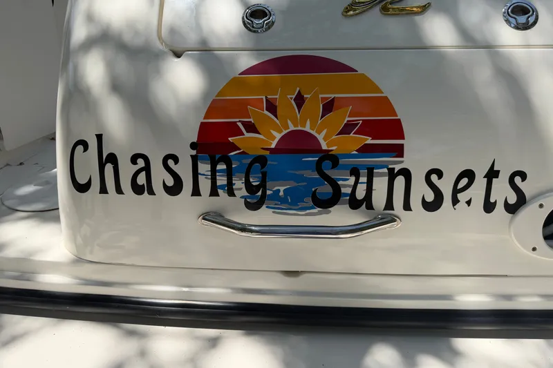 Slide: The Image of "Chasing Sunsets" graphic on 2000 Sea Ray 270 Sundancer boat, featuring a colorful sunset design. - 37