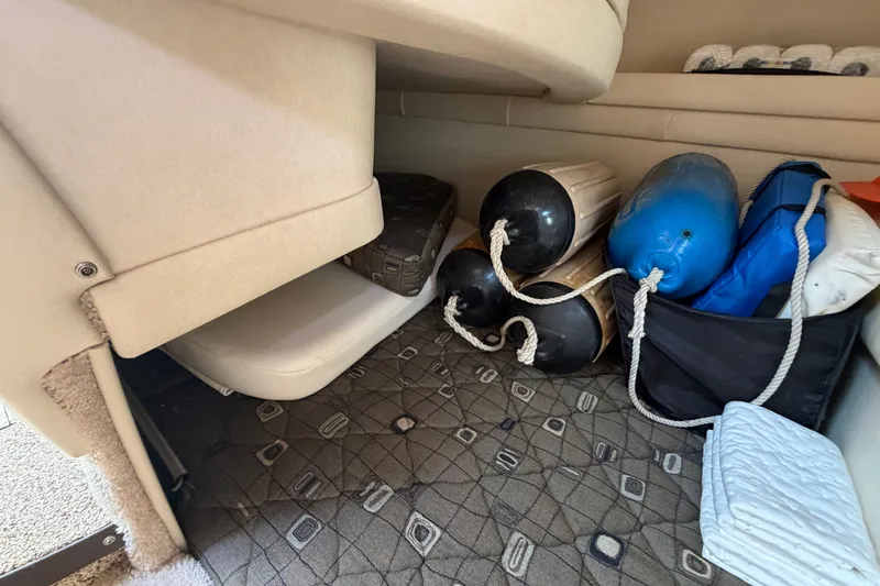 Slide: The Image of Storage area in a 2000 Sea Ray 270 Sundancer with boat fenders and cushions. - 43