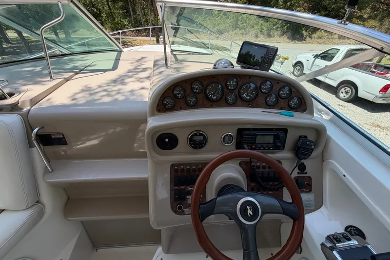 Slide: The Image of Cockpit view of 2000 Sea Ray 270 Sundancer with steering wheel and instrument panel. - 22