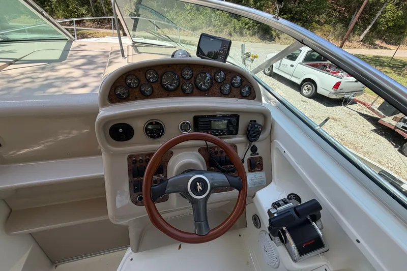 Slide: The Image of Cockpit of 2000 Sea Ray 270 Sundancer with steering wheel and control panel. - 23