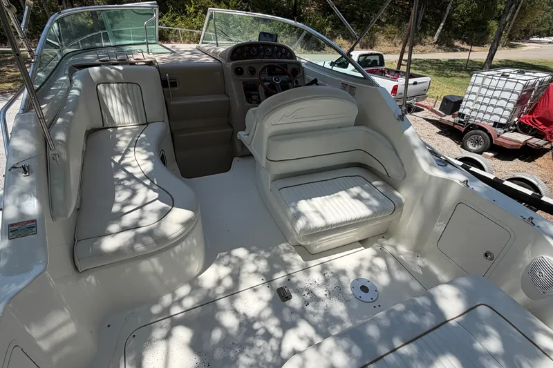 Slide: The Image of 2000 Sea Ray 270 Sundancer boat interior with white seating and dashboard. - 19