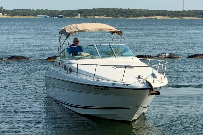 Slide: The Image of 2000 Sea Ray 270 Sundancer boat cruising on a calm lake. - 8