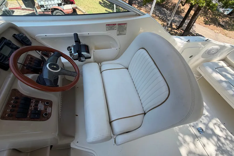 Slide: The Image of Cockpit of 2000 Sea Ray 270 Sundancer with steering wheel and white captain's seat. - 26