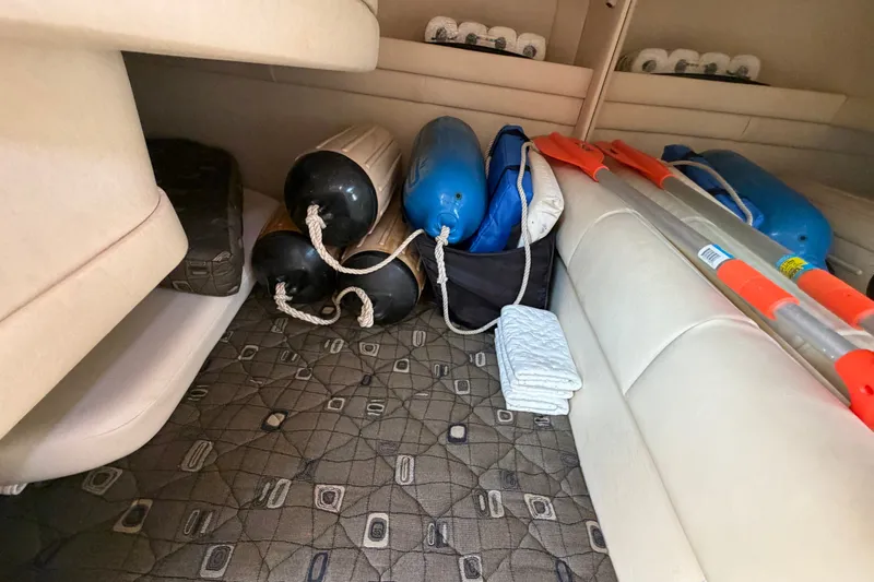 Slide: The Image of Interior storage of 2000 Sea Ray 270 Sundancer with boat fenders and paddles. - 42