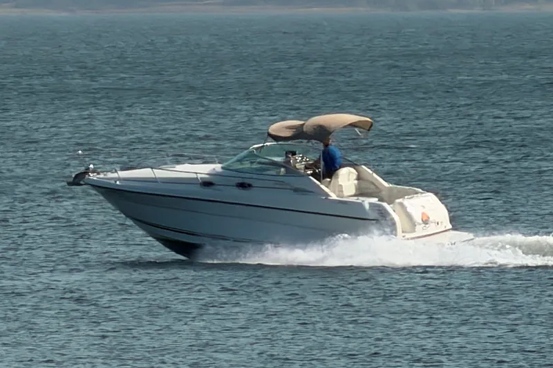Slide: The Image of 2000 Sea Ray 270 Sundancer cruising on open water. - 9