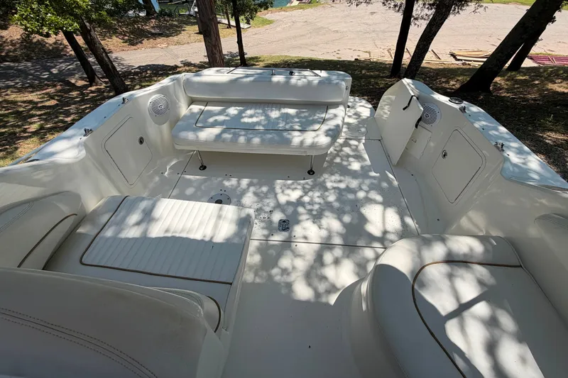 Slide: The Image of Interior view of 2000 Sea Ray 270 Sundancer boat with white seating and open storage compartments. - 28
