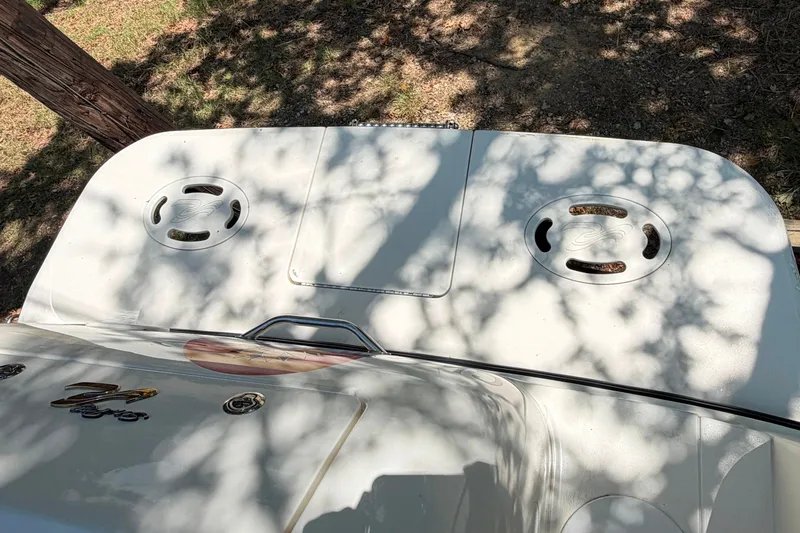 Slide: The Image of Rear view of a 2000 Sea Ray 270 Sundancer boat under tree shade. - 36