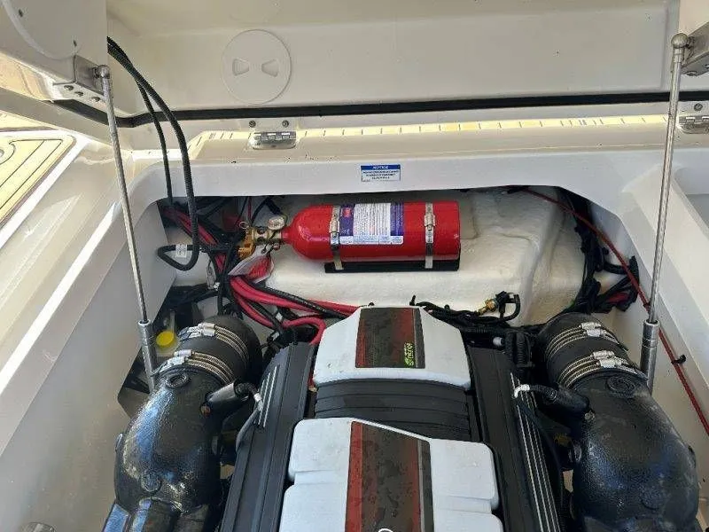 Slide: The Image of Engine compartment of 2019 Sea Ray SDX 250 with fire extinguisher. - 34