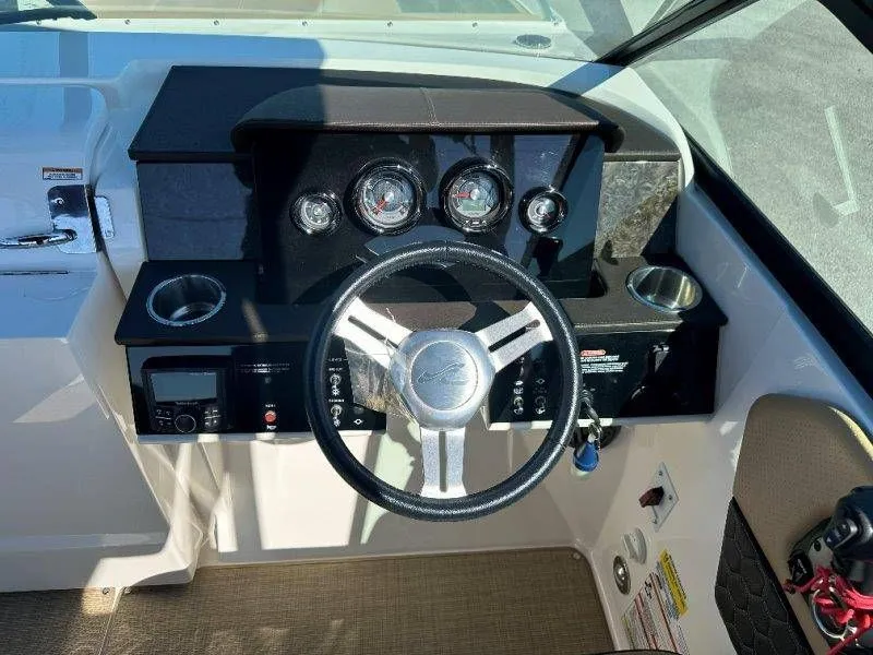 Slide: The Image of Dashboard of a 2019 Sea Ray SDX 250 boat with steering wheel and gauges. - 41