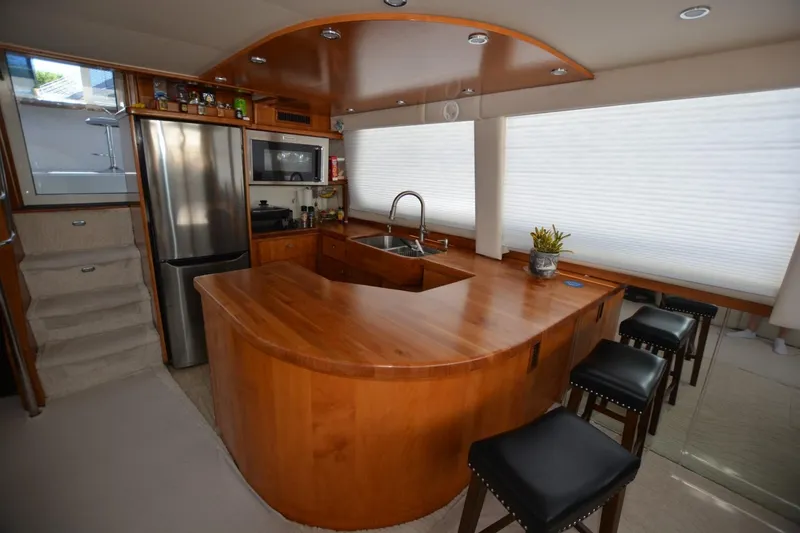 Slide: The Image of Luxurious kitchen interior of 2000 Carver 504 Cockpit Motor Yacht with wooden cabinetry and modern appliances. - 12