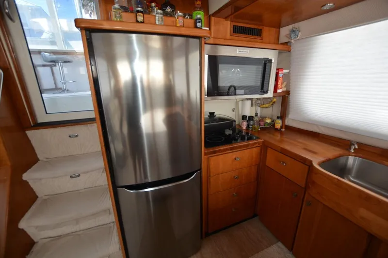 Slide: The Image of Kitchen area of 2000 Carver 504 Cockpit Motor Yacht with stainless steel appliances. - 15