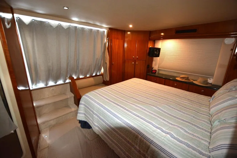 Slide: The Image of Luxurious bedroom interior of 2000 Carver 504 Cockpit Motor Yacht with wood finishes. - 17
