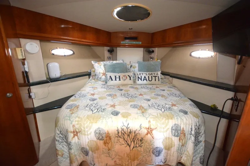 Slide: The Image of Cozy bedroom in 2000 Carver 504 Cockpit Motor Yacht with nautical-themed decor. - 21