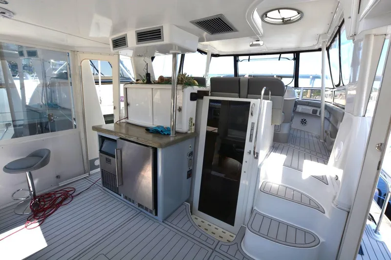 Slide: The Image of Interior of 2000 Carver 504 Cockpit Motor Yacht with modern seating and kitchenette. - 7
