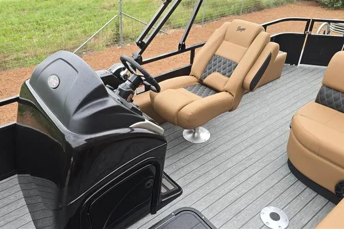 Slide: The Image of 2026 Ranger 223F boat interior with tan and black seating, steering console, and gray flooring. - 7
