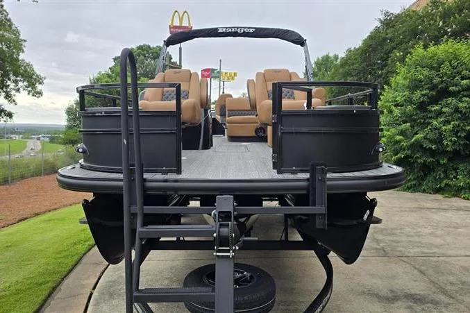 Slide: The Image of 2026 Ranger 223F pontoon boat on trailer, featuring tan seating and black exterior. - 5