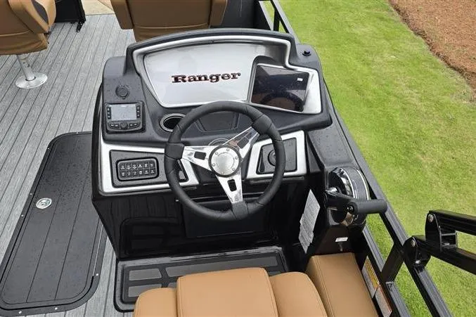 Slide: The Image of 2026 Ranger 223F boat dashboard with steering wheel, navigation controls, and seating. - 9