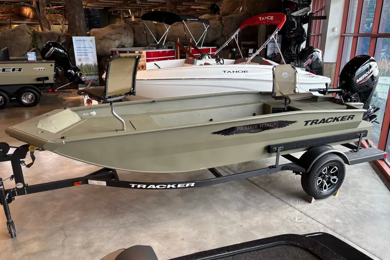 The Image of 2026 Tracker Grizzly 1650 T Prairie Wings Edition boat displayed indoors. - 0