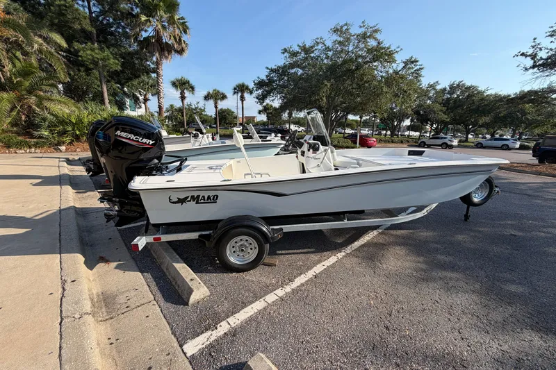 The Image of 2026 Mako Pro Skiff 17 CC boat on trailer in parking lot, sunny day. - 0