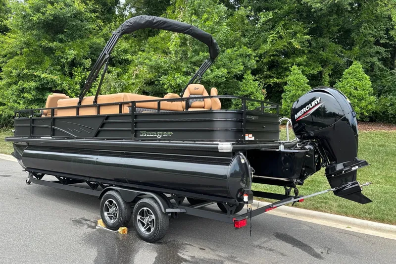 Slide: The Image of 2026 Ranger 220F pontoon boat with Mercury outboard engine, parked on a trailer. - 4