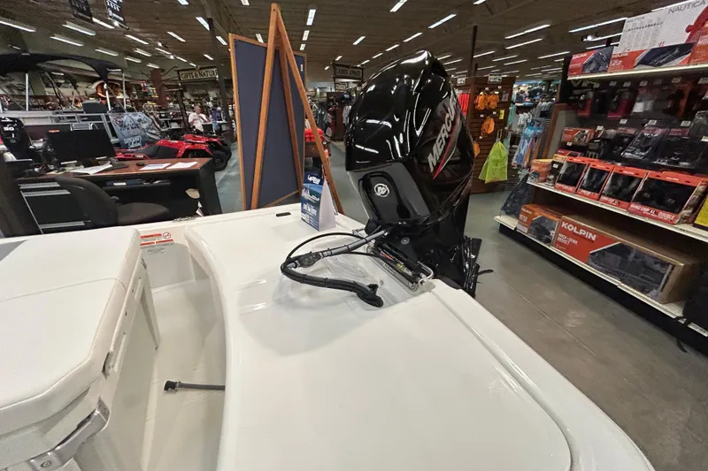 Slide: The Image of 2026 Mako Pro Skiff 15 CC with Mercury outboard motor in showroom display. - 5