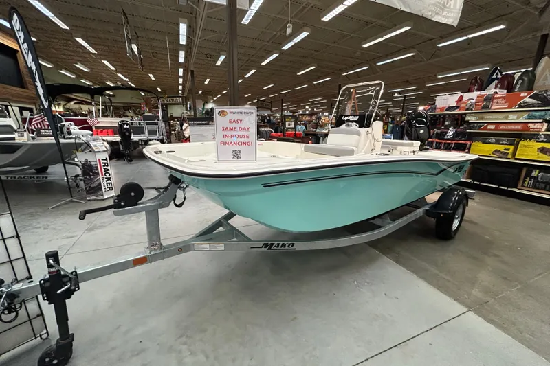 The Image of 2026 Mako Pro Skiff 15 CC boat displayed indoors on a trailer. - 0