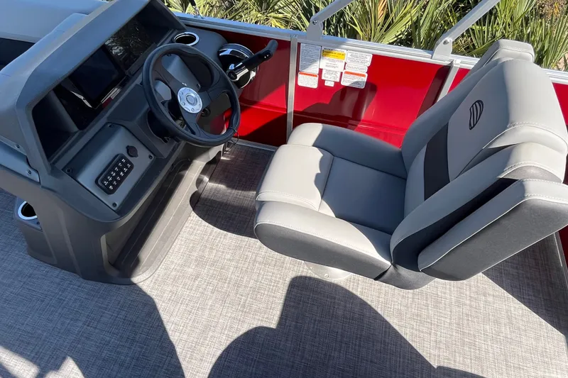 Slide: The Image of 2026 Sun Tracker Party Barge 18 DLX helm with steering wheel and captain's chair. - 18