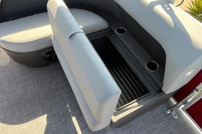 Slide: The Image of 2026 Sun Tracker Party Barge 18 DLX seating with storage compartment and cup holders. - 14