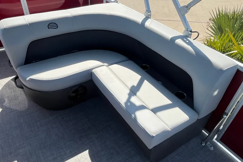 Slide: The Image of 2026 Sun Tracker Party Barge 18 DLX interior seating with cup holders and modern design. - 13