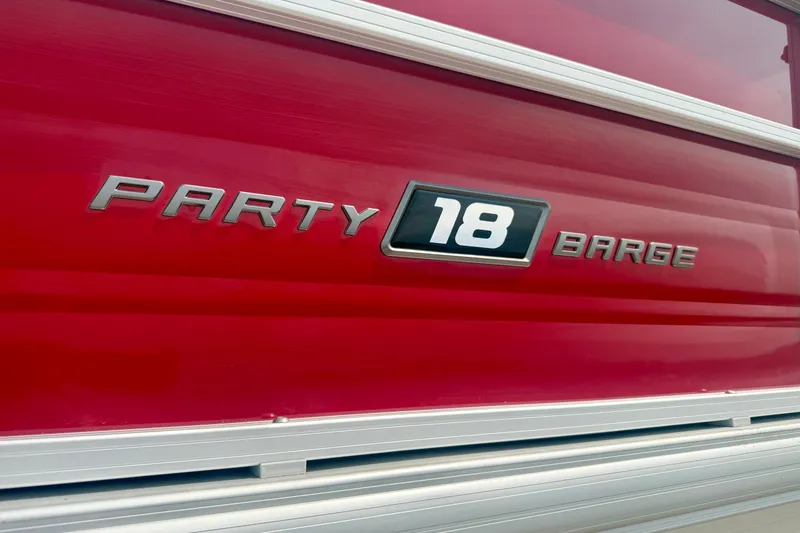 Slide: The Image of 2026 Sun Tracker Party Barge 18 DLX logo on red background. - 30