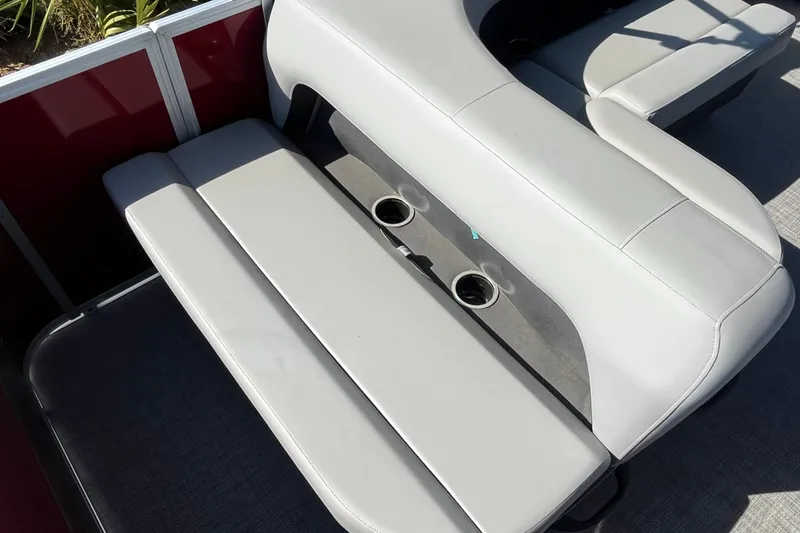 Slide: The Image of 2026 Sun Tracker Party Barge 18 DLX interior seating with cup holders. - 17