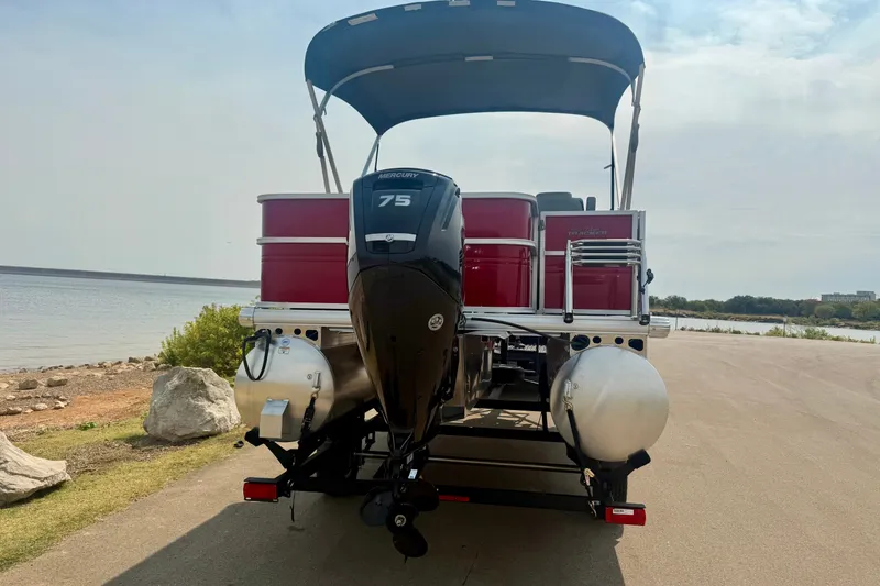 Slide: The Image of 2026 Sun Tracker Party Barge 18 DLX pontoon boat with Mercury 75 engine by a lakeside. - 26