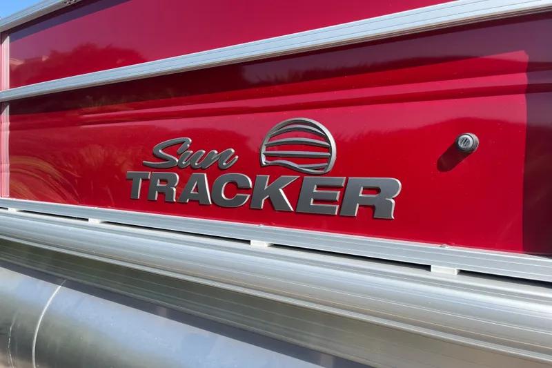 Slide: The Image of 2026 Sun Tracker Party Barge 18 DLX logo on red background. - 27